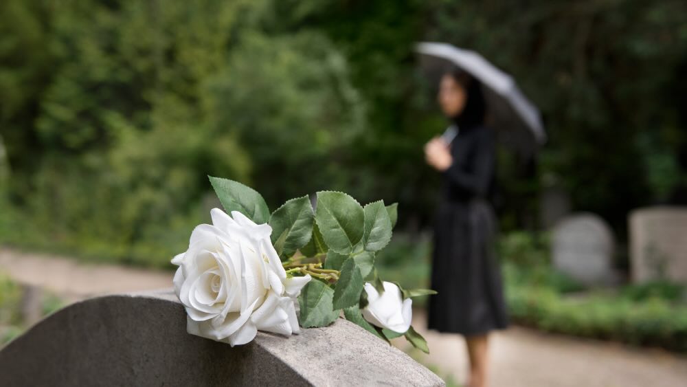 Candlelit memorial table with flowers and photographs.