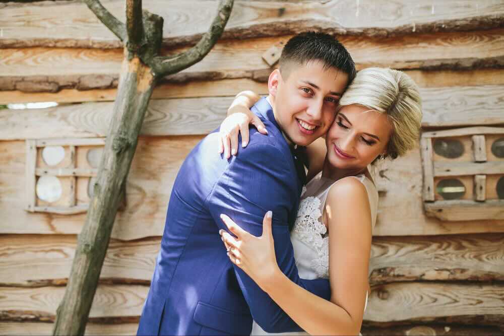 Couple laughing joyfully after a colorful wedding ceremony